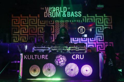 DJ booth with Kulture Cru and World of Drum & Bass signs at IHL Philly, 2024