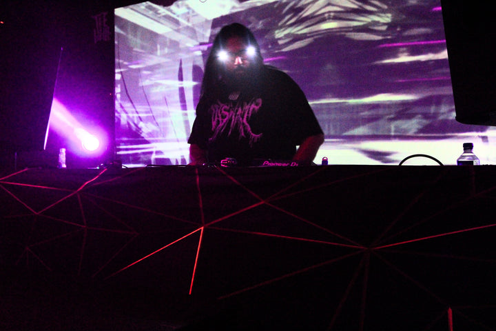 DJ in light-up goggles behind the decks under purple lights at Transmission, Las Vegas, June 2024