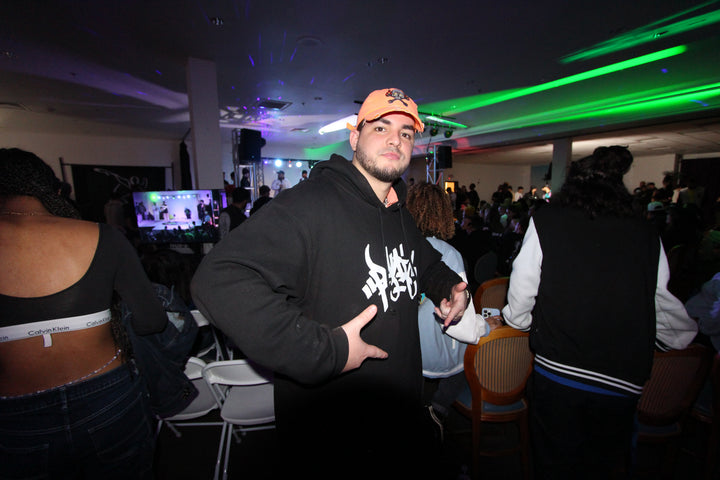 Attendee posing under green lights at Skillz Talk b-boy battle, Las Vegas, January 2024