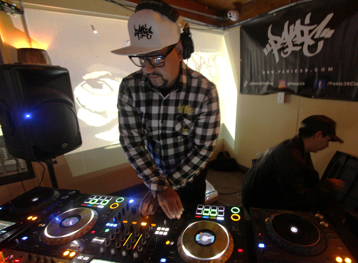DJ in a plaid shirt mixing at Desert Junglist's Ride, Big Rock Bar and Grill, Pinion Hills, 2024
