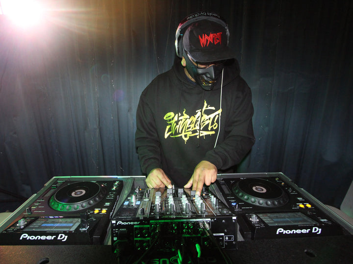 DJ in a hoodie mixing on Pioneer decks at Resinate Drum N Bass, Lancaster, February 2024