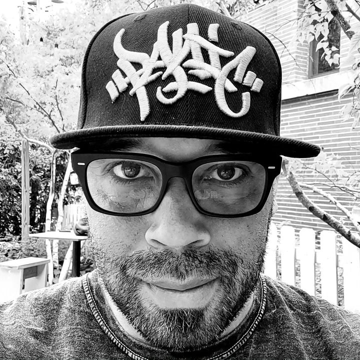 Black and white portrait of writer Kahlil Crawford in a Panic 39 cap