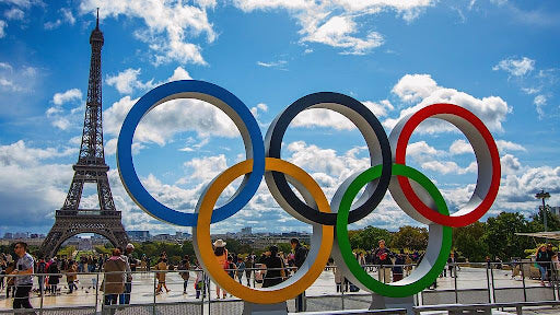 Olympic rings in Paris with the Eiffel Tower behind them