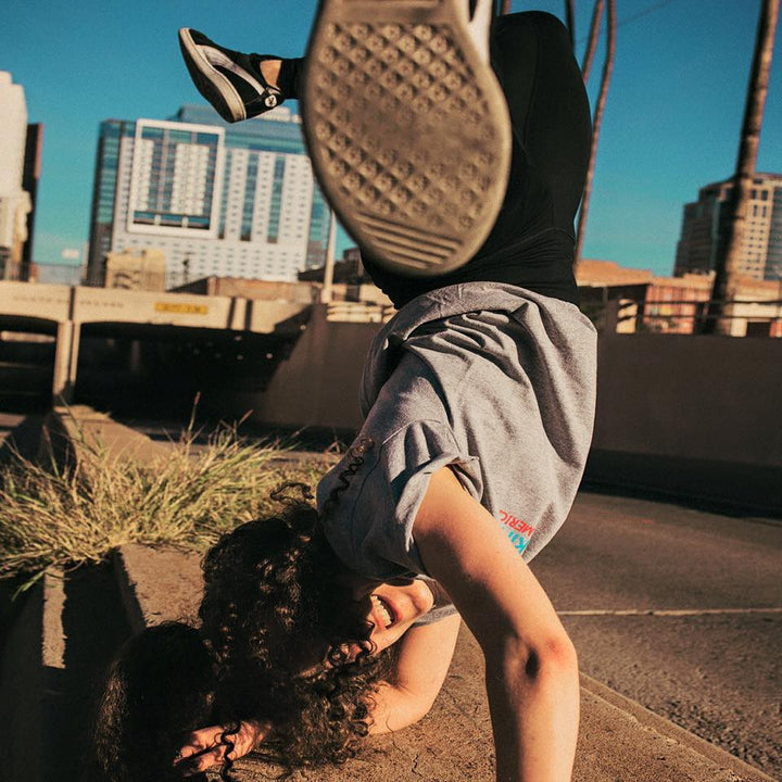 B-Girl Maggie Waller in a freeze on a city sidewalk