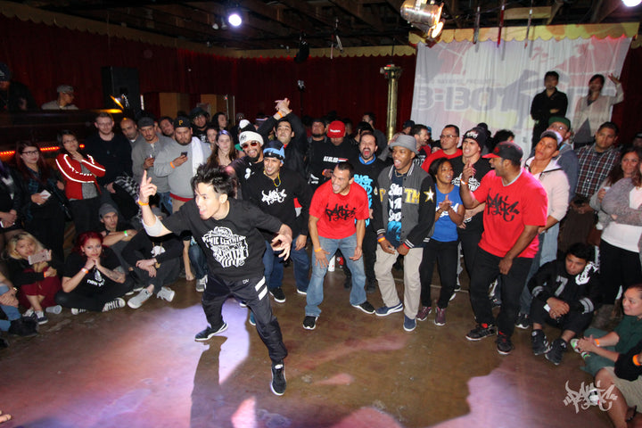 B-boy going off in the circle at a battle with the crowd watching