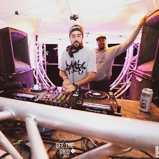 House DJ mixing on the decks at an Off The Grid event
