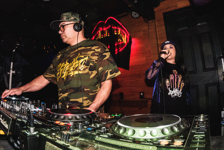 DJ in camo with headphones and an MC on the mic at Santos Bar, New Orleans, February 2024
