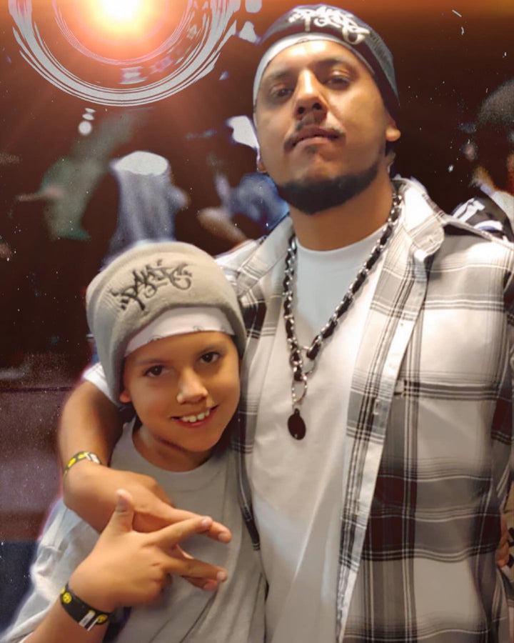 Popping Tronick of Funny Bones Crew with his son at an event